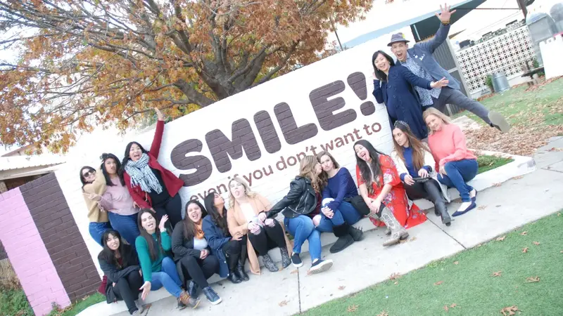The Petite Dental team in front of their SMILE mural